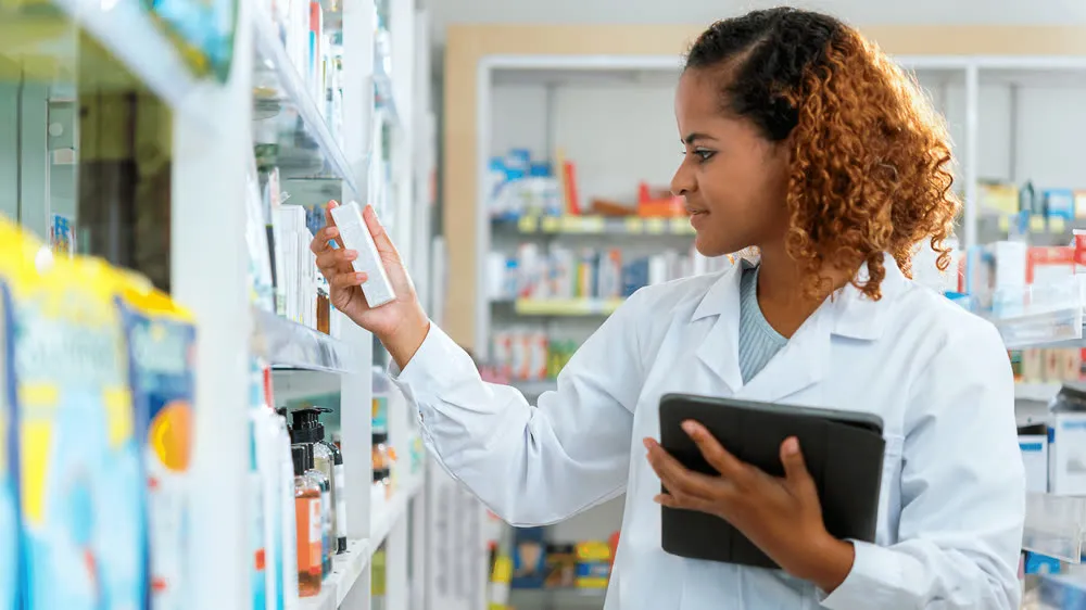 A pharmacist checking stock on the shelves